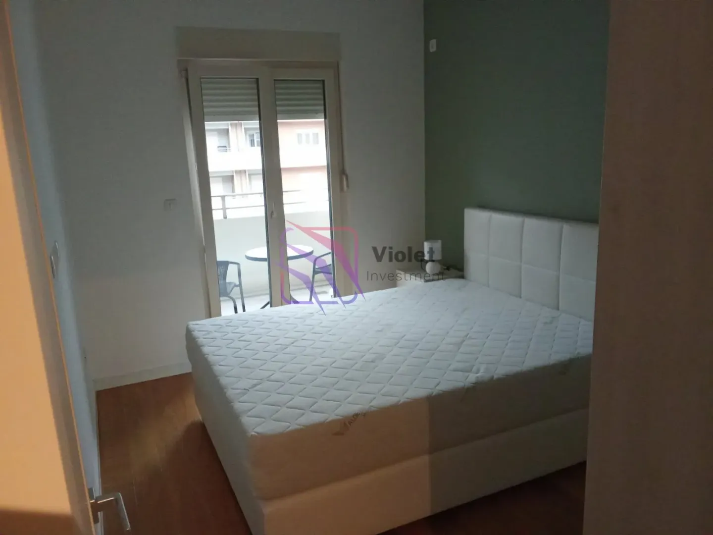 Bedroom with a double bed and balcony access.