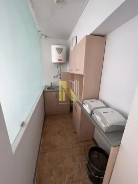 Smaller kitchen with cabinets and water heater. - image 6