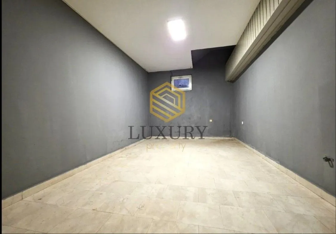 Empty room with gray walls and ceramic floor tiles.