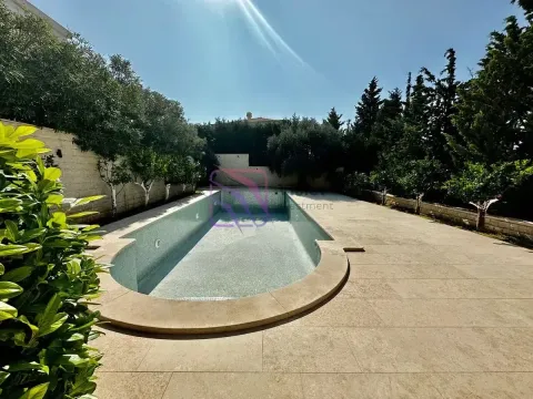 Pogled na spoljašnji bazen sa popločanim platoom i uređenim zelenilom u dvorištu. - image 8