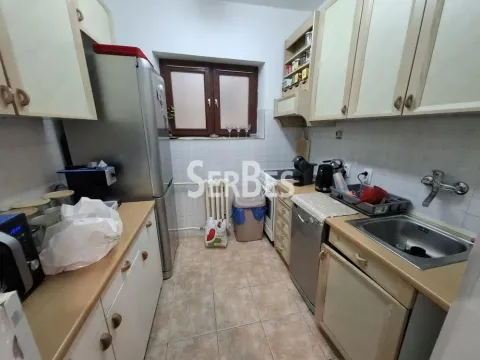 Manja kuhinja sa drvenim elementima, frižiderom i prozorom. - image 14