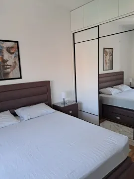 Comfortable bedroom with a double bed and a large built-in wardrobe with a mirror. - image 6