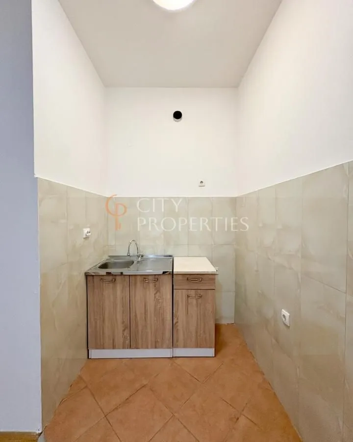Smaller kitchen with a sink and cabinets in a niche.