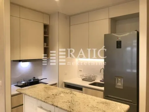 Modern kitchen with light cabinetry and a breakfast bar. - image 3