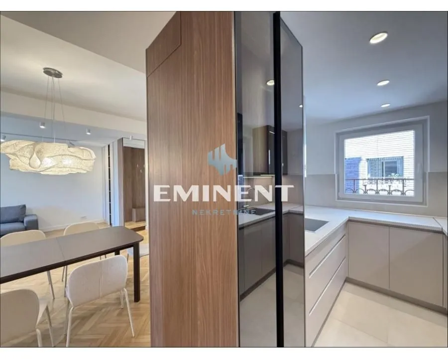 Modern kitchen with built-in appliances connected to the dining area.