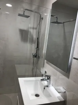 Modern bathroom with a shower cabin and a white sink. - image 15