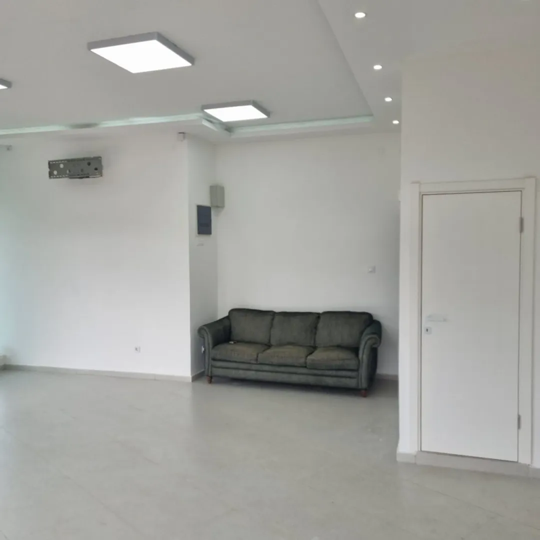 Bright and spacious room with a single sofa.
