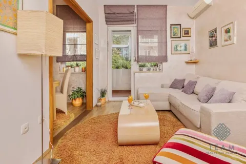 Living room with a sofa, coffee table and access to the terrace. - image 2