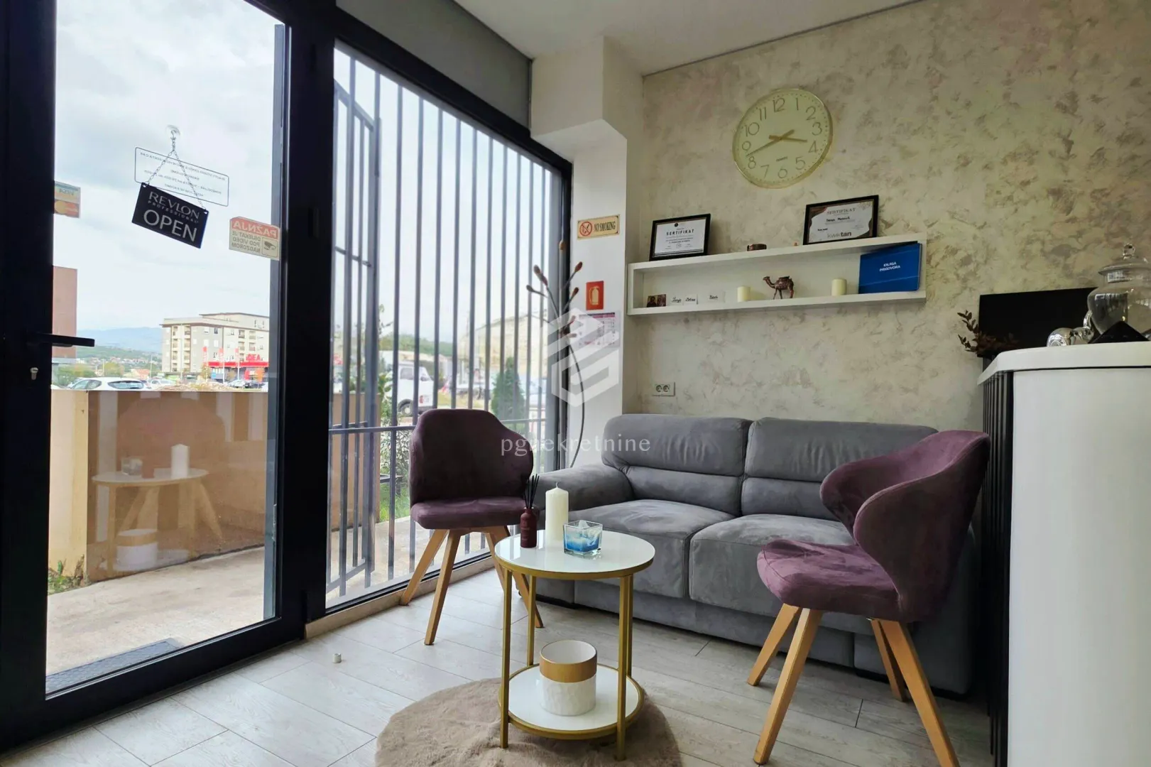 Living room with a grey sofa, two purple armchairs, and a small coffee table.