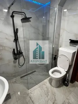 Modern bathroom with a walk-in shower, glass screen and toilet. - image 12