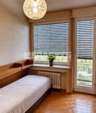 Small bedroom with a bed, a window, and access to the terrace. - image 2