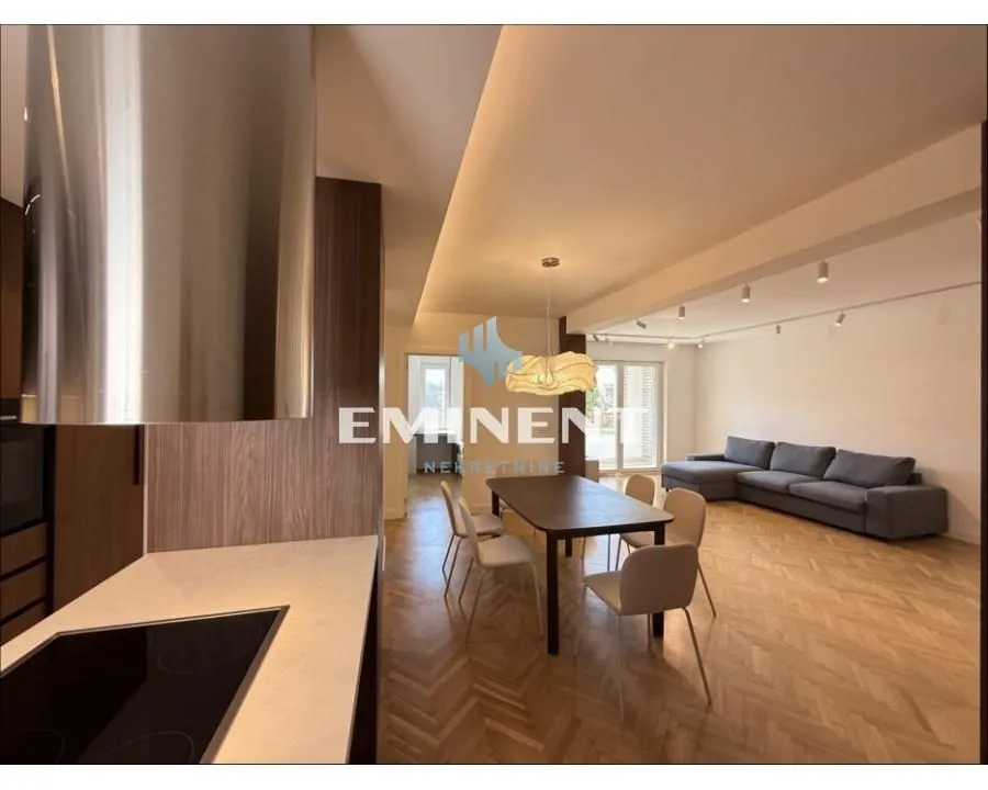 Open plan living room with dining area and kitchen.