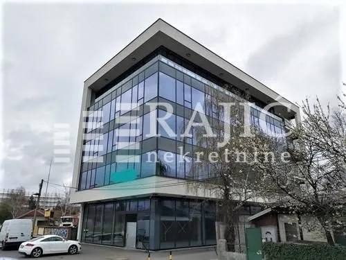 Exterior of a modern commercial building with a glass facade.