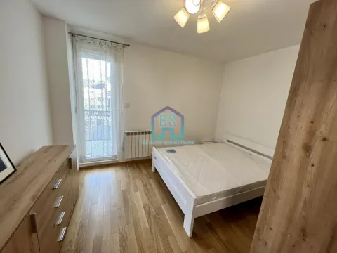 Bedroom with a double bed, wooden furniture, and access to a terrace. - image 7