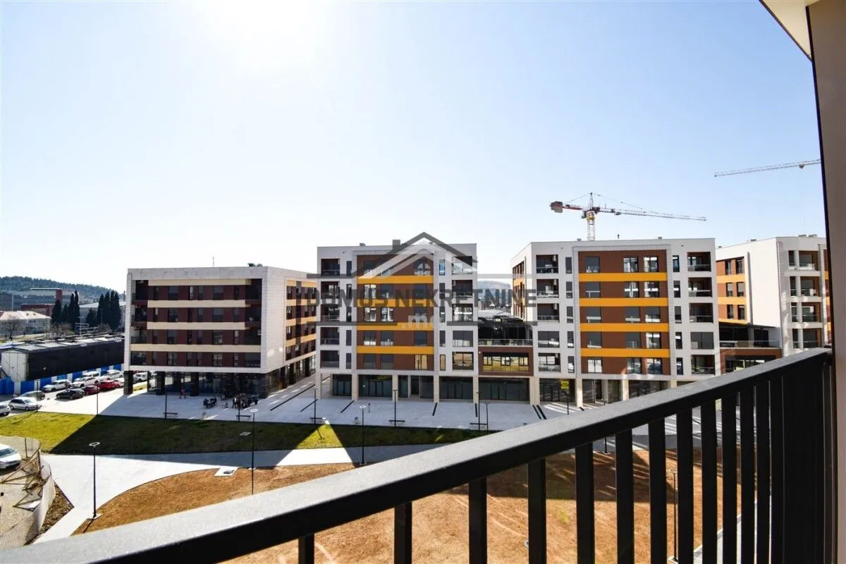 View from the balcony overlooking residential buildings and courtyard.