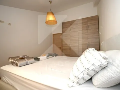 Furnished bedroom with a double bed and built-in wardrobe. - image 8