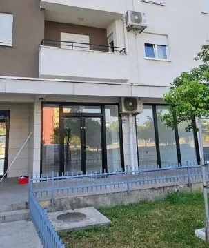 Exterior view of a commercial space on the ground floor of a building with large glass storefront. - image 2