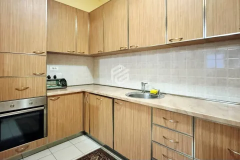 Kitchen with wooden cabinetry, built-in oven, and sink. - image 7