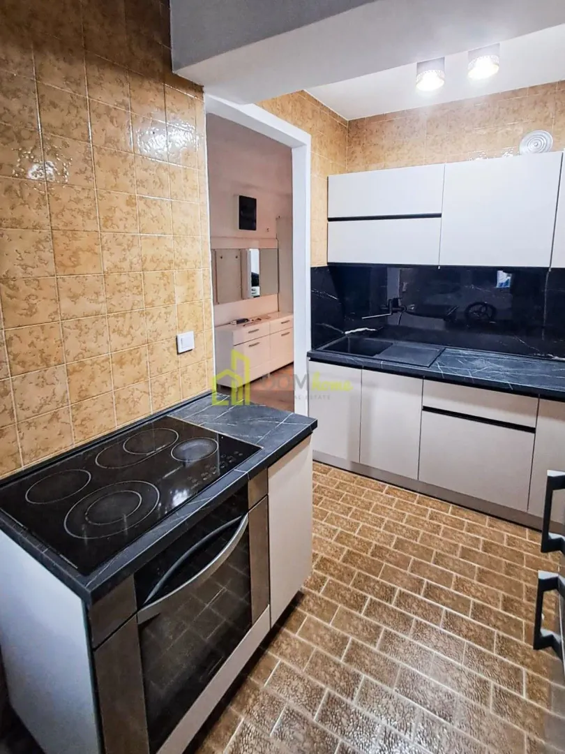 Kitchen with cabinets and a built-in cooktop and oven.