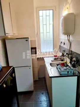 Small kitchen with a refrigerator, sink, and a window. - image 6