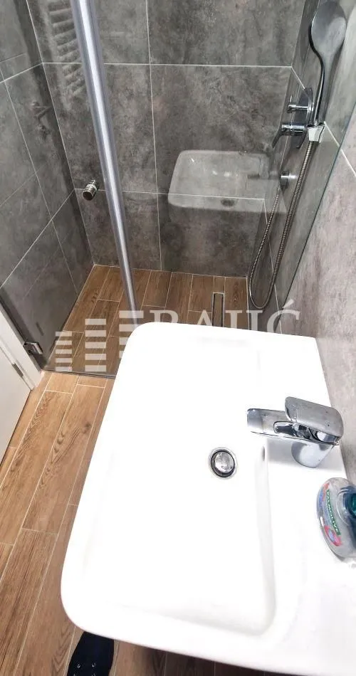 Modern bathroom with a sink and a shower cabin.