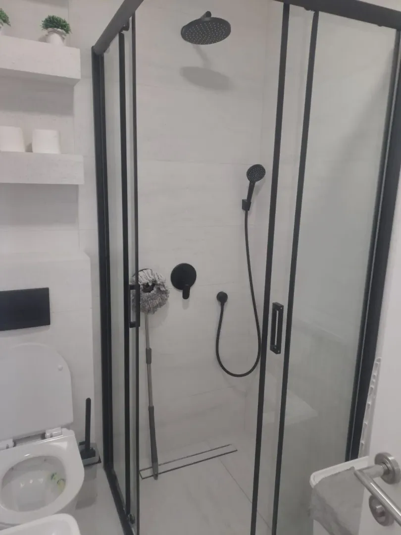 Modern bathroom with a walk-in shower and built-in fixtures.