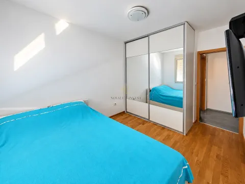 Bedroom with a double bed, large wardrobe, and wooden flooring. - image 7