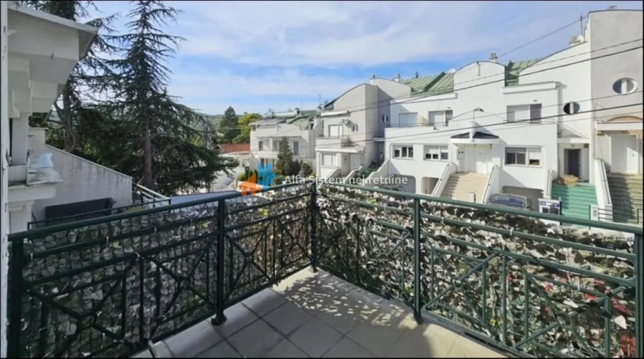 View from the balcony overlooking surrounding buildings and neighborhood.