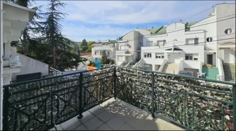 View from the balcony overlooking surrounding buildings and neighborhood. - image 6