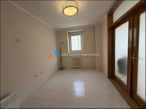 Empty room with ceramic floor tiles and wooden double doors. - image 16