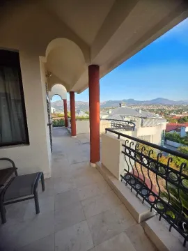 Spacious covered terrace with pillars and a view of the surroundings. - image 20