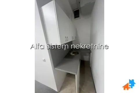 Small white kitchen with a sink and wall cabinets. - image 11