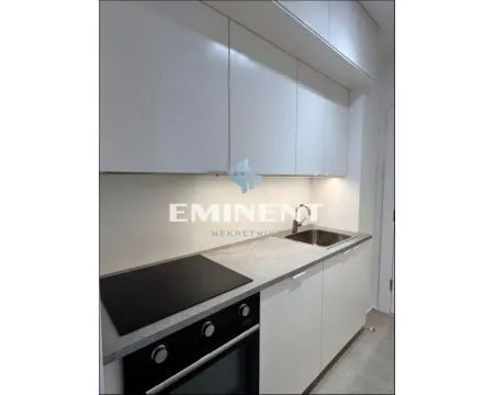 Modern white kitchen with built-in oven and sink. - image 5