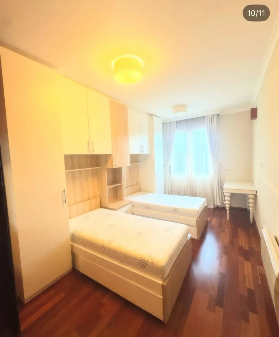 Children's bedroom with two single beds and a wardrobe.