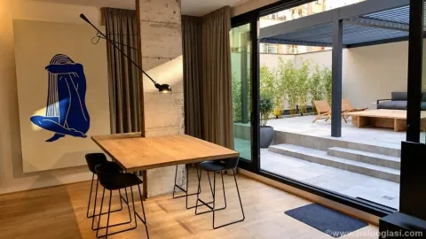 Living room with a dining table and a view of the terrace. - image 9