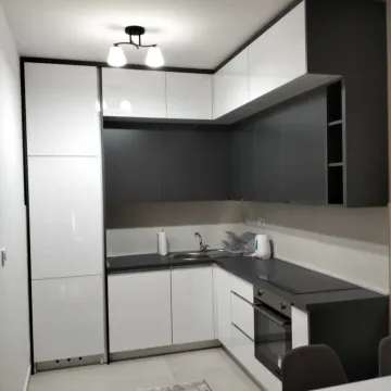 Modern kitchen in white and gray tones with built-in appliances. - image 9