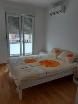 Bright bedroom with a double bed and an air conditioning unit. - image 6