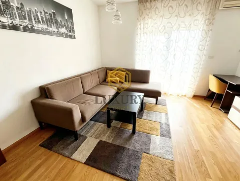 Living room with a sectional sofa, coffee table, and rug. - image 4