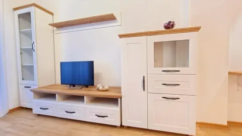 Living room with white furniture unit and a television. - image 3