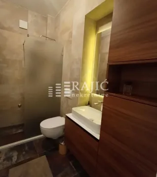 Modernly equipped bathroom with a washbasin and walk-in shower. - image 4