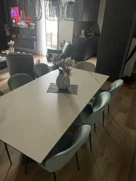 Dining area with a modern table and chairs, connected to the living room and kitchen. - image 7