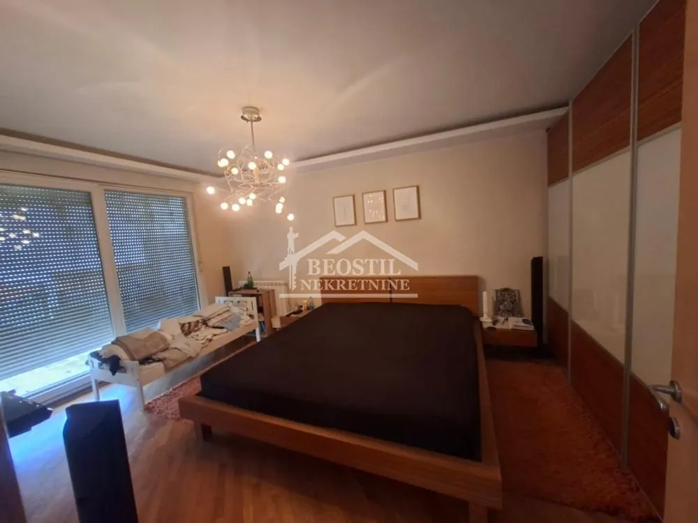 Furnished bedroom with a double bed and a large wardrobe.