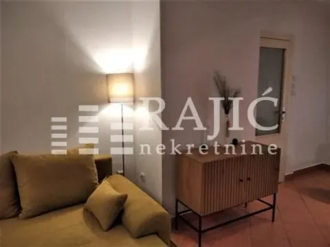 Living room with a corner sofa, floor lamp, and a sideboard. - image 4