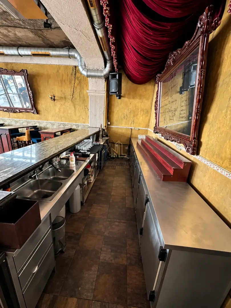 Commercial kitchen with a bar counter and professional equipment.