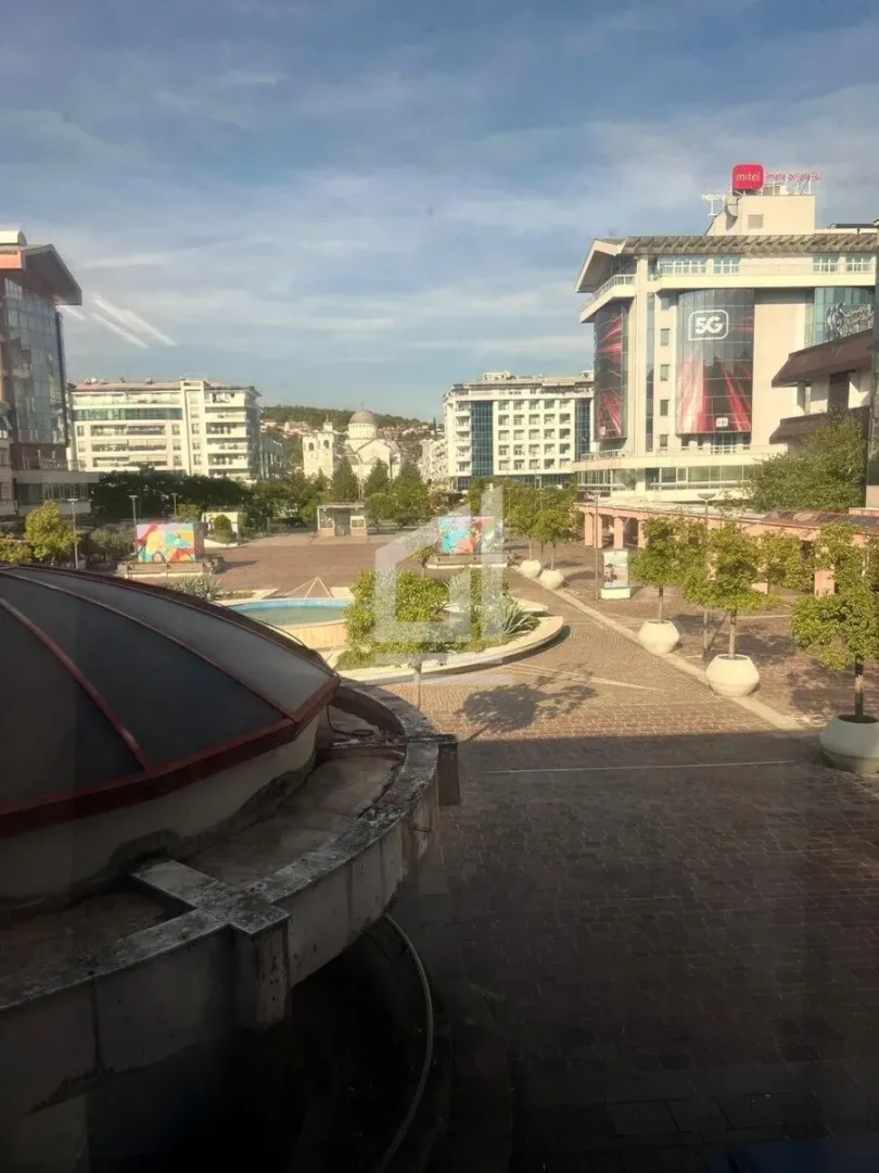 View from the window of the city square and surrounding buildings.