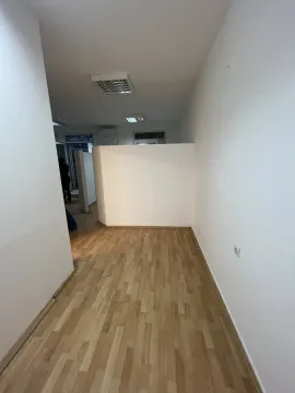 An empty room with laminate flooring and white walls. - image 3