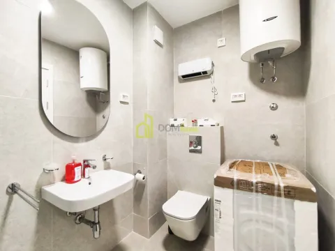 Modern bathroom equipped with sanitary ware and a mirror. - image 3
