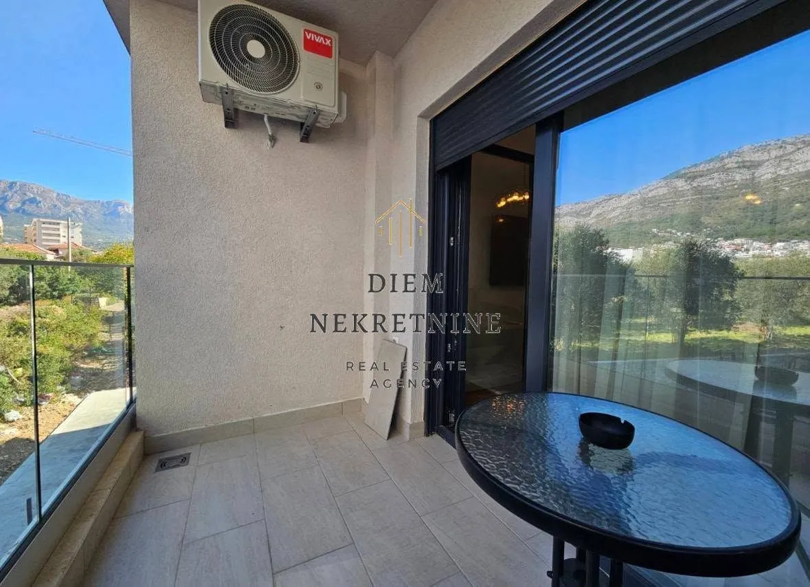 Covered terrace with a table and surrounding view.