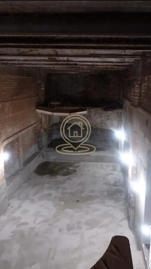 Unfinished space under construction with exposed walls and a concrete floor.