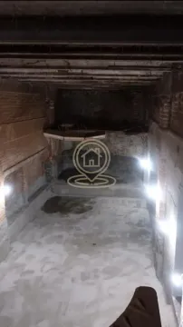 Unfinished space under construction with exposed walls and a concrete floor. - image 3